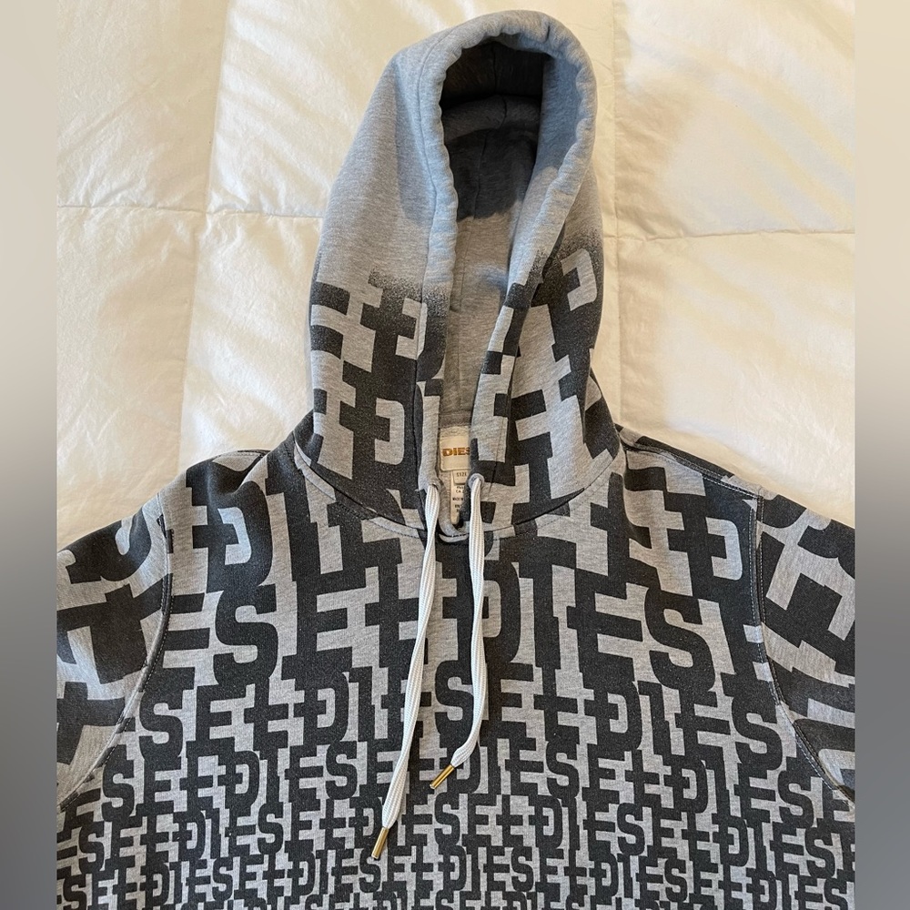 Grey Diesel Hoodie with graphic “DIESEL” letters imprinted large to very small.